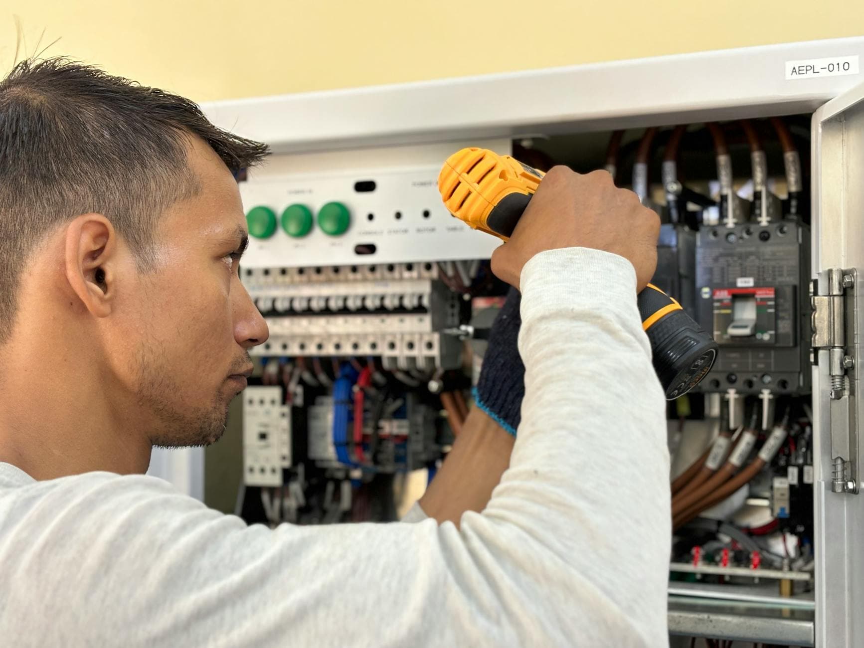 Professional electrician working on electrical panel installation showing skilled electrical contractor services
