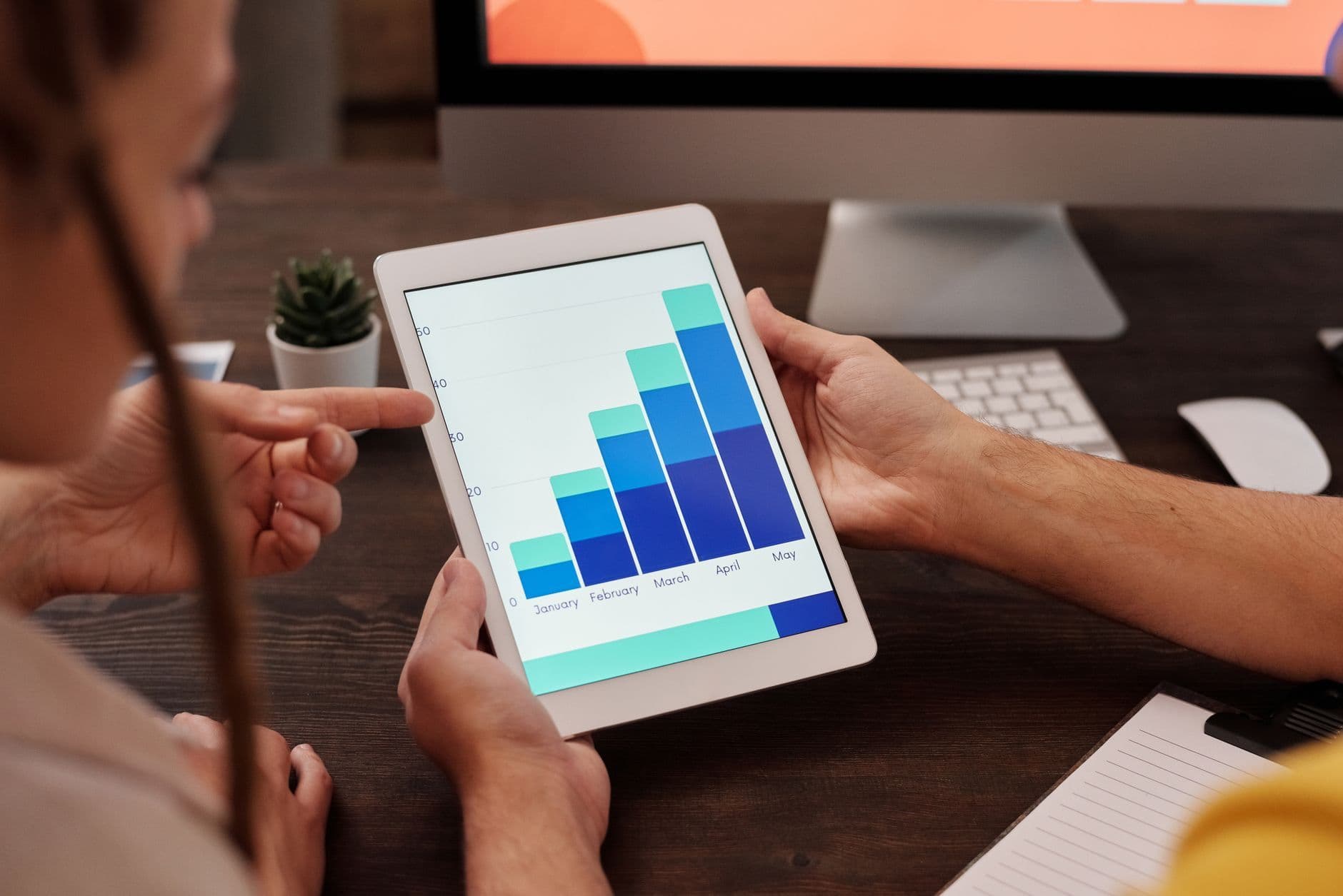 Web designer reviewing local SEO analytics and site performance with a Metro Detroit small business owner